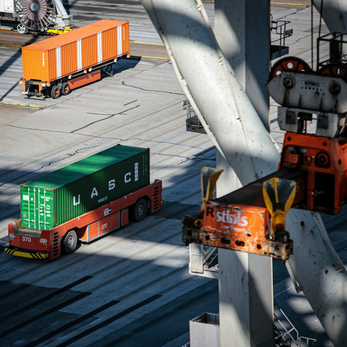 a cargo truck driving down a road next to a loading dock